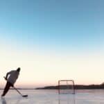 a hockey player skating and shooting pucks outdoor